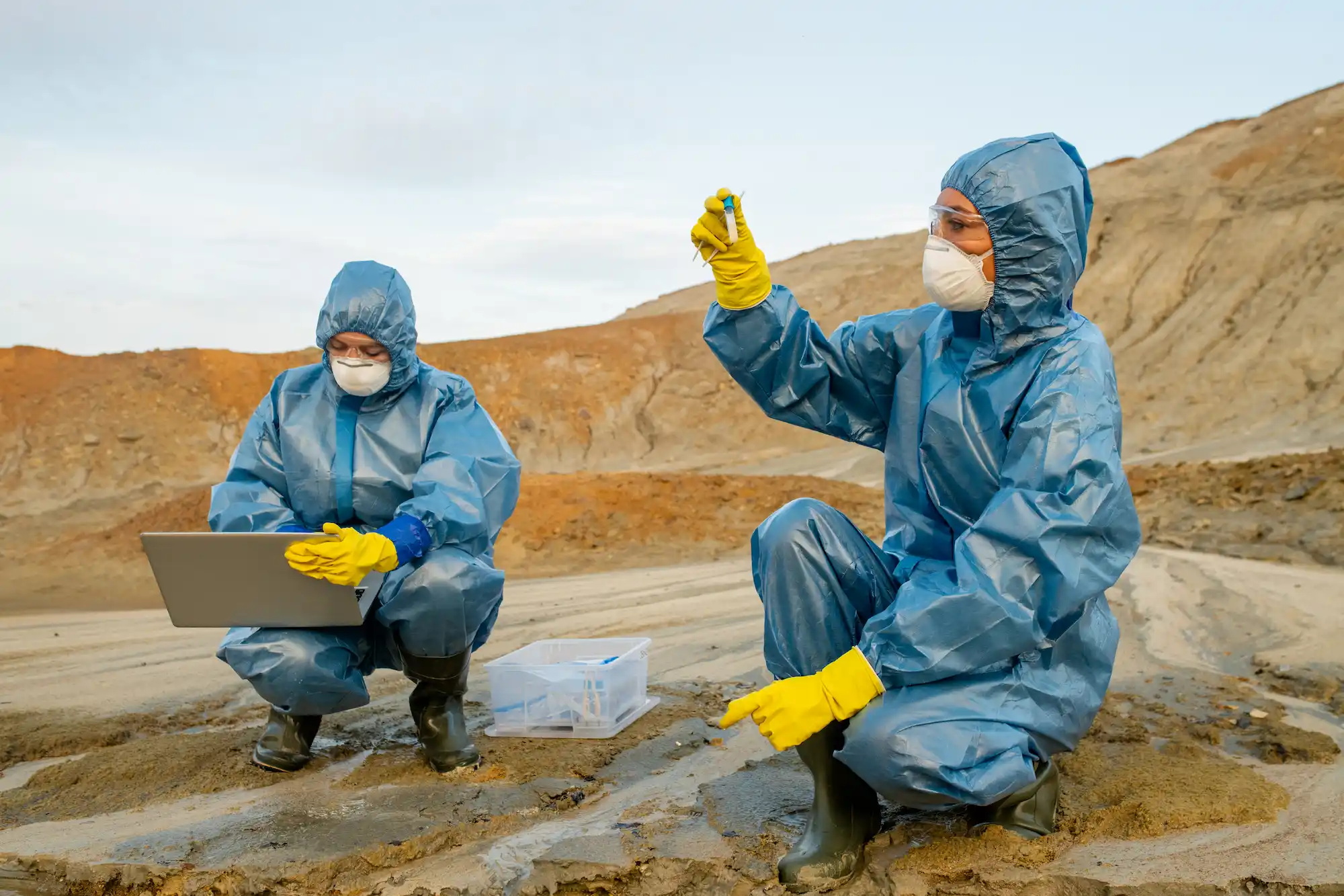 Young ecologists studying characteristics of toxic water in polluted area