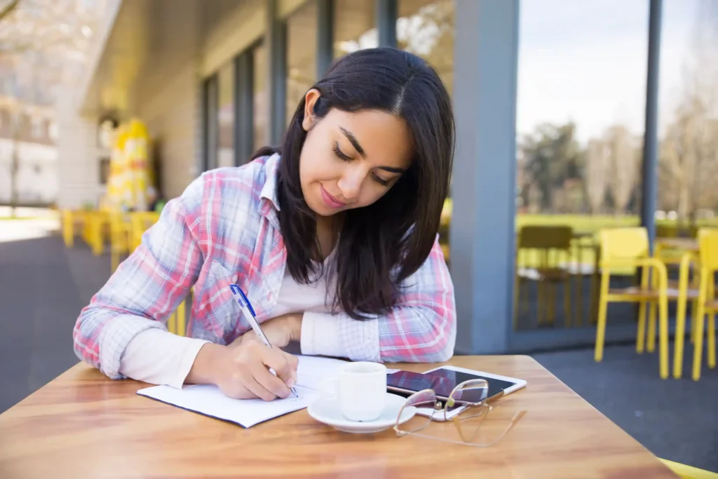 a young girl writing on a paper