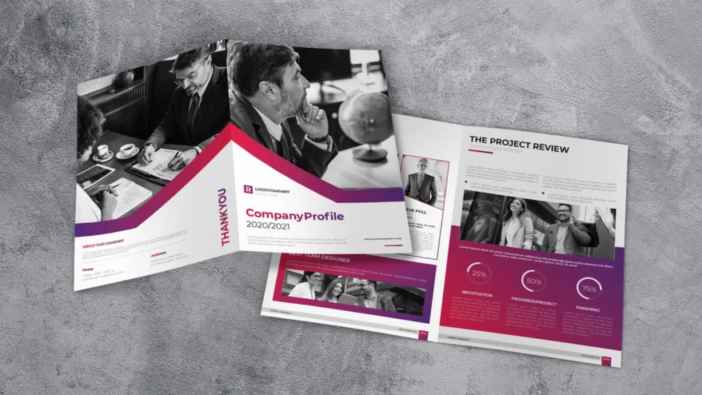 A modern, professional company profile design template featuring a mix of black-and-white business photos, bold magenta and purple accents, and clean typography. The pages display sections like 'About Our Company,' 'The Project Review,' and team introductions, laid out on a gray textured background.